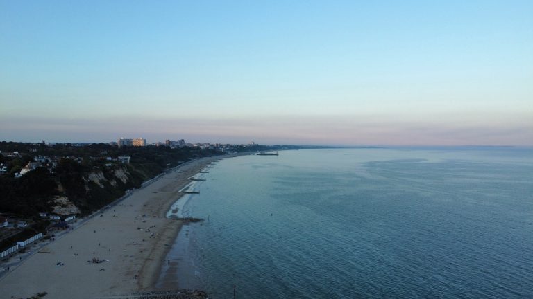 Aerial view of Bournemouth pier and coastline from a drone